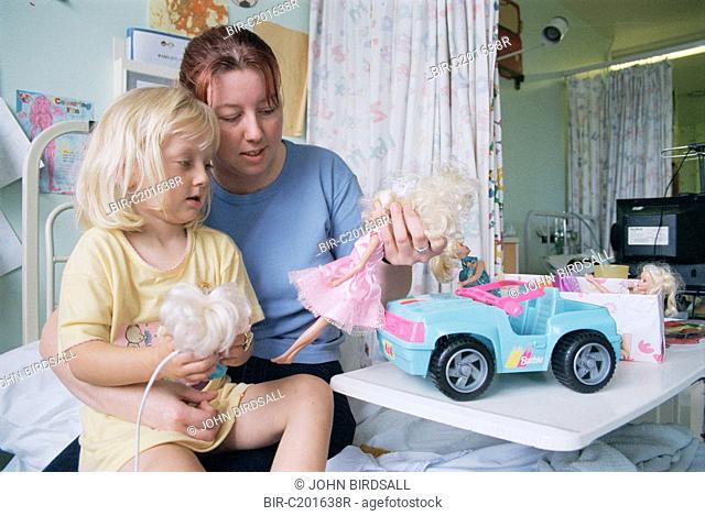 Mother playing with child on children's ward in hospital
