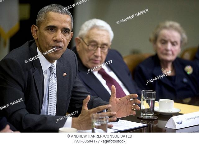 United States President Barack Obama, left, speaks while meeting with current and former diplomatic and national security officials including Henry Kissinger