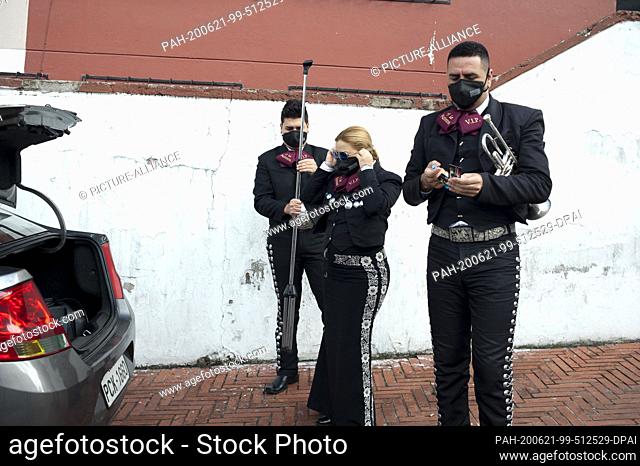 21 June 2020, Ecuador, Quito: Musicians of the Eine Mariachi group ""Mariachis a la Mexicana"" wear mouthguards after their performance as part of the Father's...