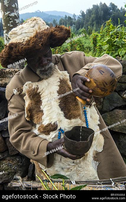 Old man preparing local herbs on a Ceremony of former poachers, in the Virunga National Park, Rwanda, Africa