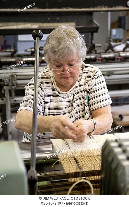 Amana, Iowa - A worker operates a loom at the Amana Woolen Mill  The Woolen Mill is one of the enterprises started when German immigrants established the...