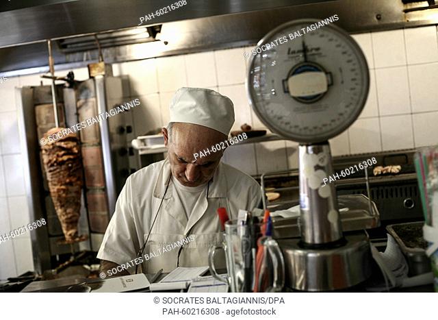 A roaster prepares a traditional Greek souvlaki at a taverna in Athens, Greece, 20 July 2015. Greek banks reopened on July 20 after a shutdown lasting three...