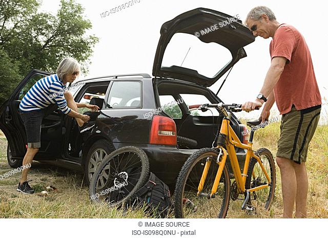 Couple with car and bicycle