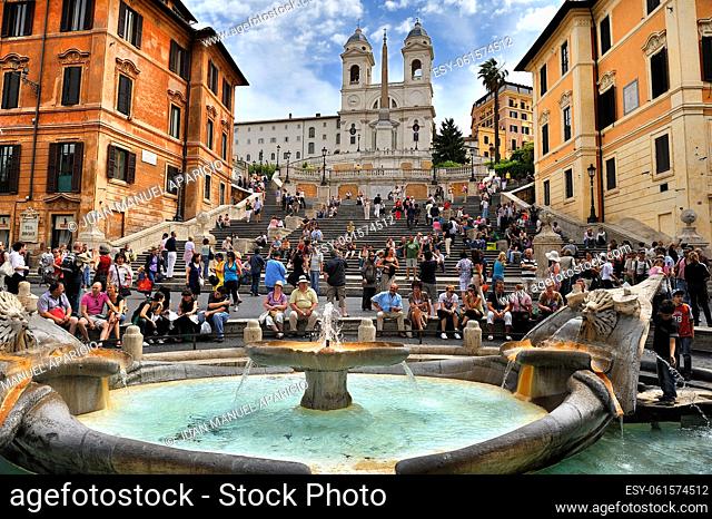 View from the source of the barge in Spain Plaza Rome people sitting on stairs, Trinity Church of the mountain and the bottom Obelisk