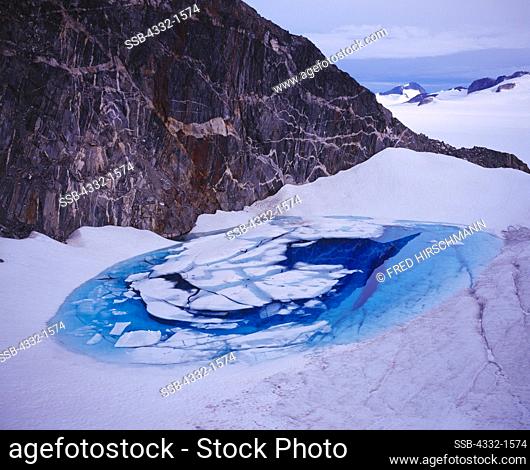 Deep blue glacial melt water pool by Echo Mountain, Juneau Icefield, Tongass National Forest, Alaska