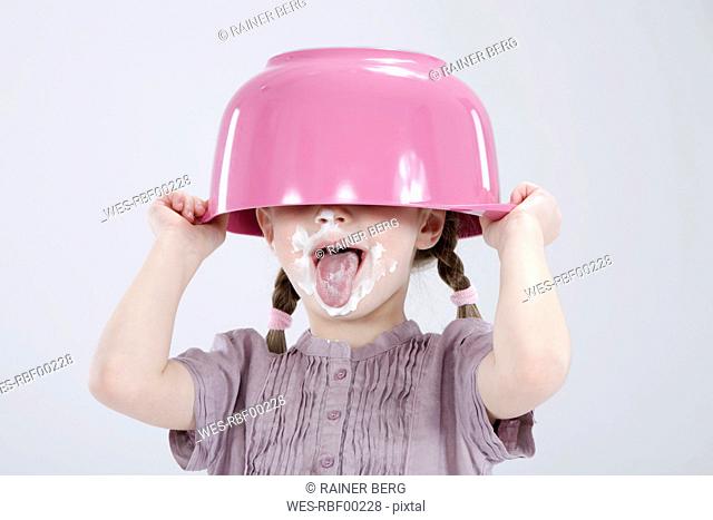 Girl 4-5 with messy face wearing bowl hat