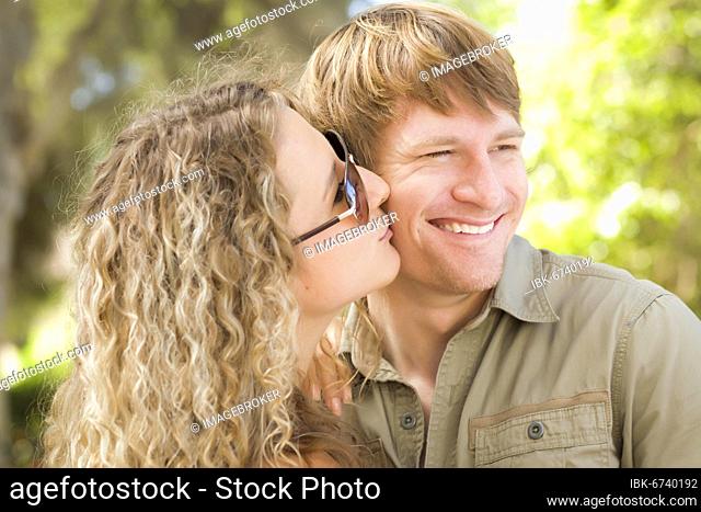 Happy attractive loving couple portrait in the park