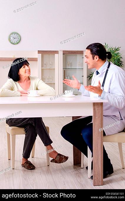 The young doctor examining senior old woman
