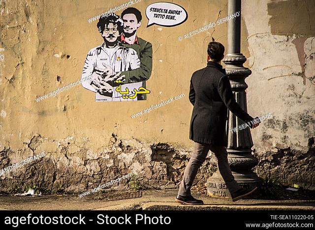 A view of a mural believed to be made by street artist Laika portraying Patrick George Zaky (L) wearing an inmate uniform and being embraced by Giulio Regeni...