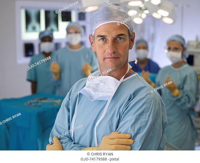 Surgeon in operating room in scrubs with arms crossed