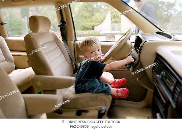 Child at car's steering wheel