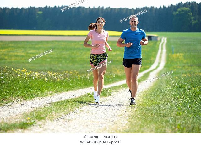 Couple running on field path