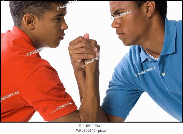 Close-up of two young men arm wrestling