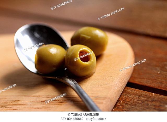 filled olives on a spoon