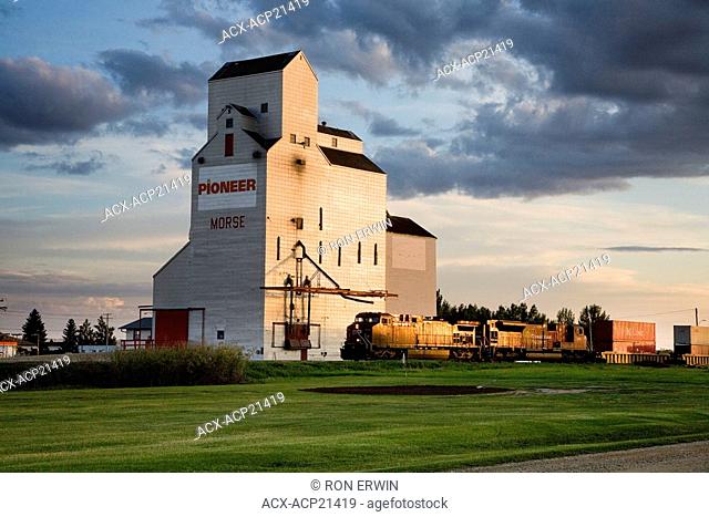 A train passes by the Grain Elevators and the Reed Lake Golf Club in Morse, Saskatchewan, Canada