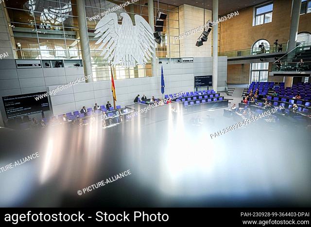 28 September 2023, Berlin: Members of parliament attend the session of the Bundestag. In the foreground, the railing of the press gallery can be seen out of...