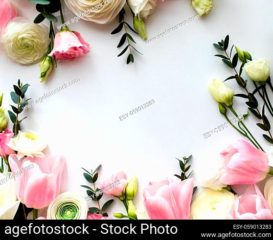 Pink and white flowers border design over the white background, top view