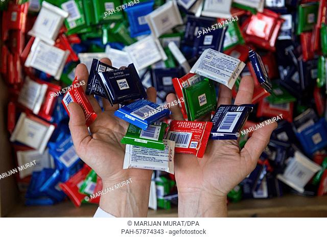 A staff member of chocolate manufacturer Ritter Sport presents miniature editions of chocolate bars with different flavours at the production site of Ritter...