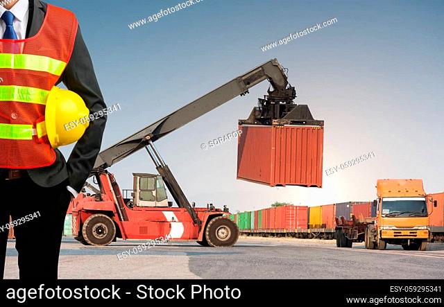 Businessman stand on front forklift loading Containers box to Logistic cargo Import Export