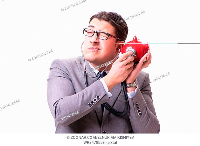 Businessman with stethoscope and piggybank isolated withe background