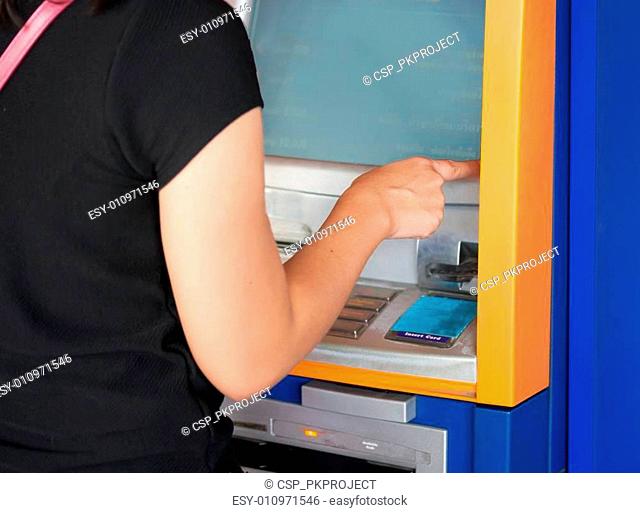 Women pressing ATM machine