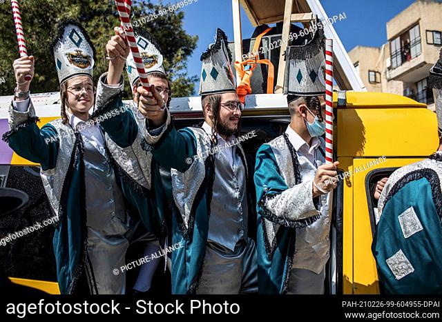26 February 2021, Israel, Bnei Brak: Ultra orthodox Jewish men in traditional costumes take part in celebrations marking Purim, also called the Festival of Lots