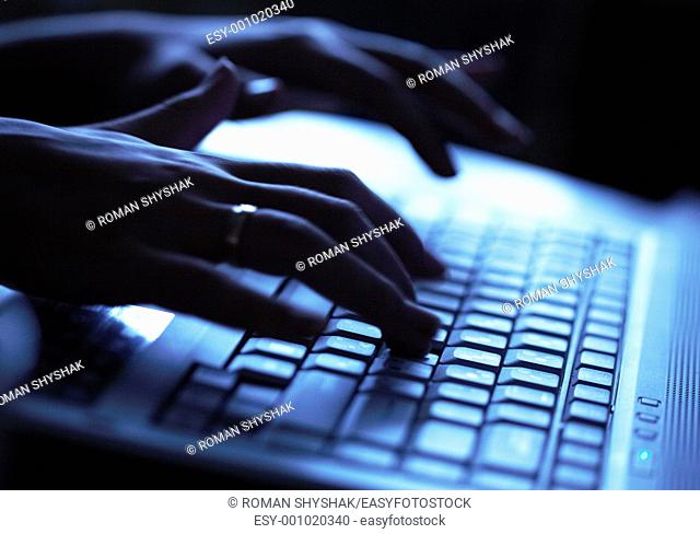 Close up of a hands typing on laptop keyboard