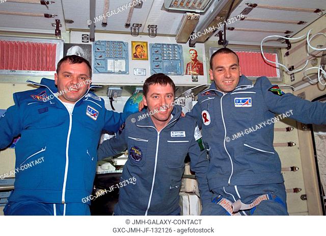 The Soyuz Taxi crewmembers pose for a group photo in the Zvezda Service Module on the International Space Station (ISS). From the left are Commander Yuri...