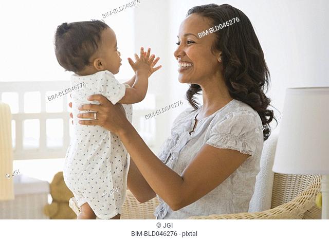 African American mother smiling at baby