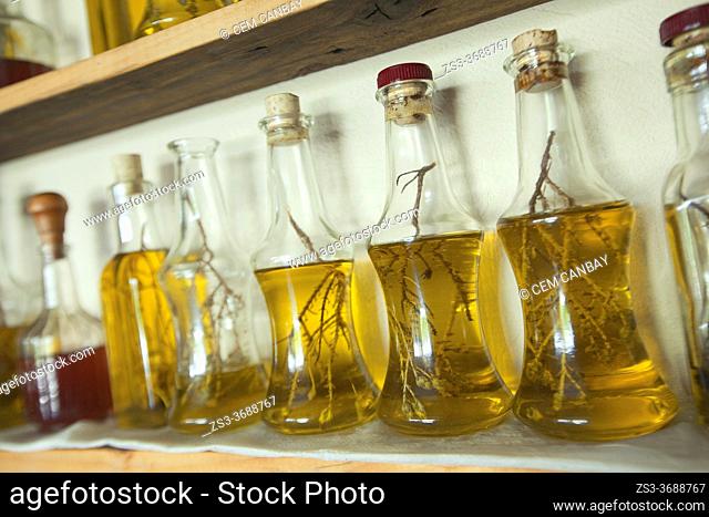 Close-Up shot to the bottles of olive oil cans on the shelf of a restuarant, Rethymno Region, Crete, Greek Islands, Greece, Europe
