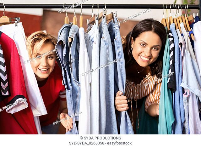 women having fun at vintage clothing store hanger