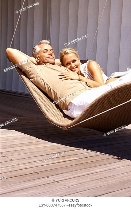 Portrait of a senior old couple relaxing in hammock
