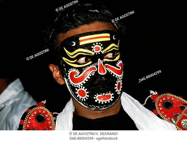 Actor with face painted during a Kathakali performance, Indian dance-drama, Karthica Thirunal Theatre, Kerala, India