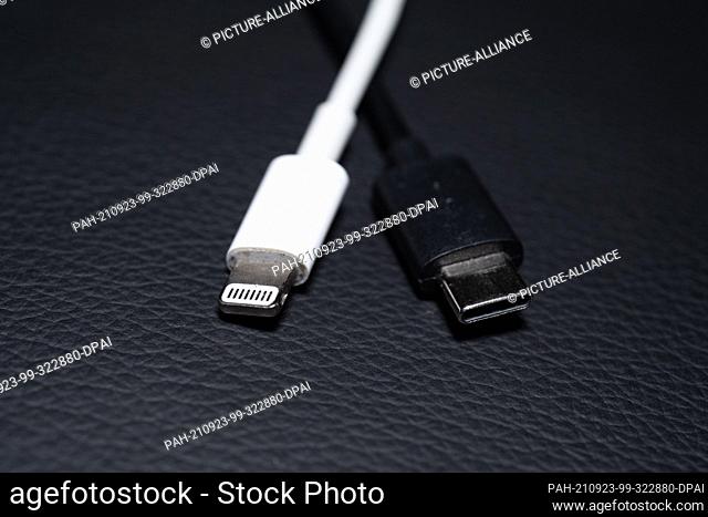 22 September 2021, Lower Saxony, Oldenburg: An Apple Lightning charging plug (l) is seen next to a USB-C charging plug. EU Commission presents proposal for...