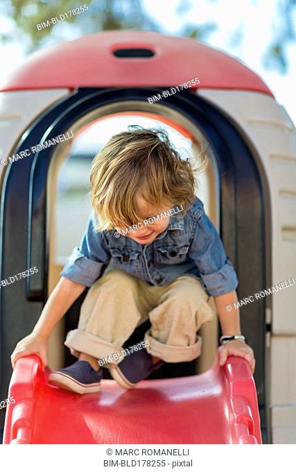 Caucasian boy playing at playground