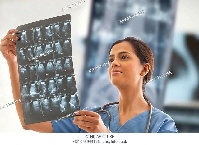 Young female surgeon analyzing ultrasound report