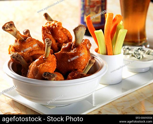 Buffalo chicken wings with carrot and celery sticks and blue cheese dip