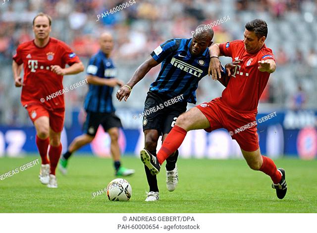Oliver Kreuzer (R) of FC Bayern AllStars and David Suazo of Inter Forever vie for the ball during an all-stars soccer match following a team presenation of...