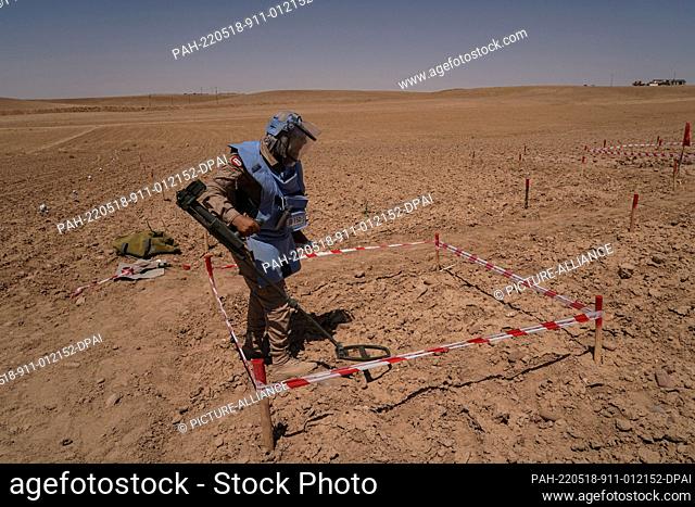 18 May 2022, Iraq, Tal al-Reem: A female member of the Swiss Foundation for Mine Action (FSD) uses a mine detector at the village of Tal al-Reem