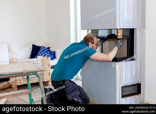 Man installing fireplace