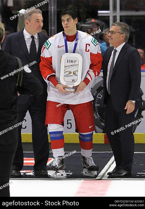Captain of Russian team Grigori Denisenko, centre, receives from Vladislav Tretyak, left, and President of the International Ice Hockey Federation (IIHF) Rene...