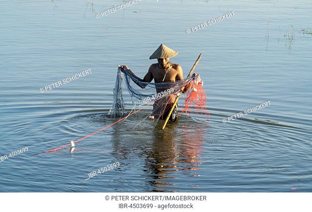 Fishermen with net in Taungthaman Lake, Amarapura, Mandalay, Myanmar