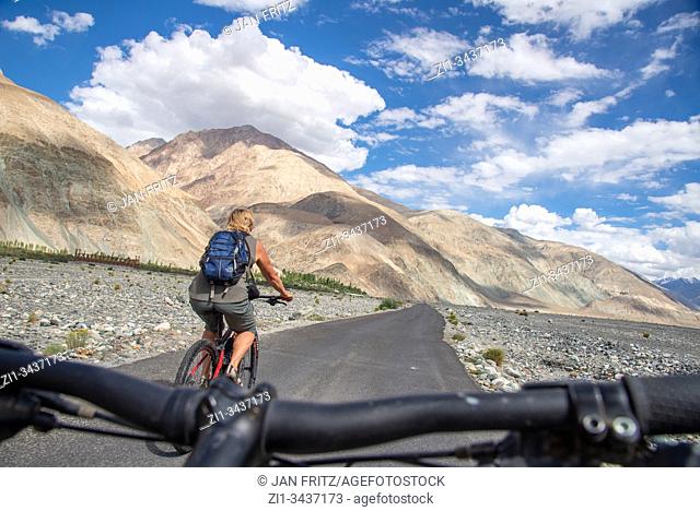 cyclist in Nubra and Shyok valley in Himalayas in Ladakh, northern India