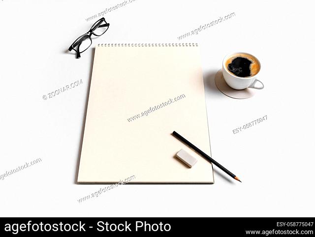 Photo of blank sketchbook, coffee cup, glasses, pencil and eraser on paper background. Blank stationery set. Responsive design template