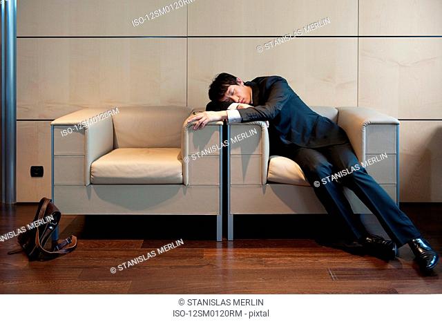 Chinese businessman sleeping in office