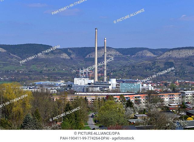10 April 2019, Thuringia, Jena: The chimneys of the TEAG heating power plant in Jena are visible from afar. Here the demolition of the last large coal chimney...