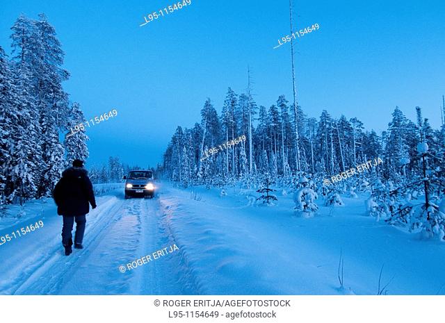 Van car crossing Taiga forest, Kuhmo, Finland, near the Russian border in February