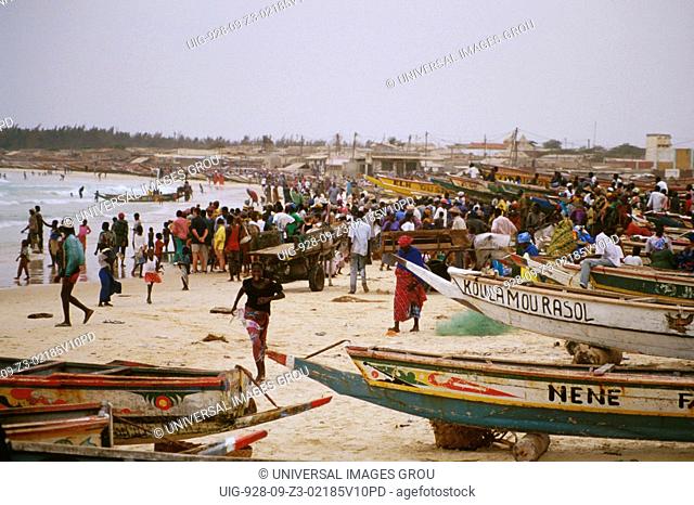 Senegal, Kayar. Bringing In The Catch, Crowd Of Men, Women & Children On The Beach Among Boats & Primal Fishing Gear