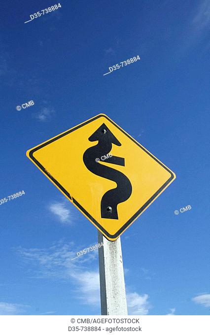 Yellow road sign: winding street, Hwy 75, Little River, Akaroa, East Coast, South Island, New Zealand