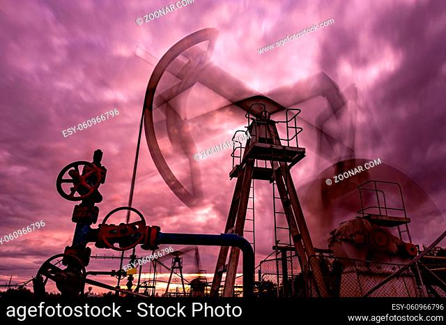 Oil pump rig. Oil and gas production. Oilfield site. Pump Jack are running. Drilling derricks for fossil fuels output and crude oil production